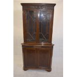 A Georgian style mahogany corner cabinet, with astragal glazed top section over panel door base, 212