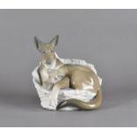 A Lladro figure group, modelled as alsation dog and puppy lying in basket, blue mark to base,