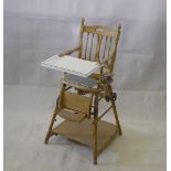 An Edwardian pine metamorphic child's high chair, with replacement table, original loose, 103 cm