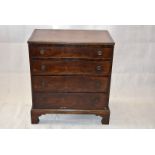 A small flame mahogany chest of four graduated long drawers, with ring handles on bracket feet, 80