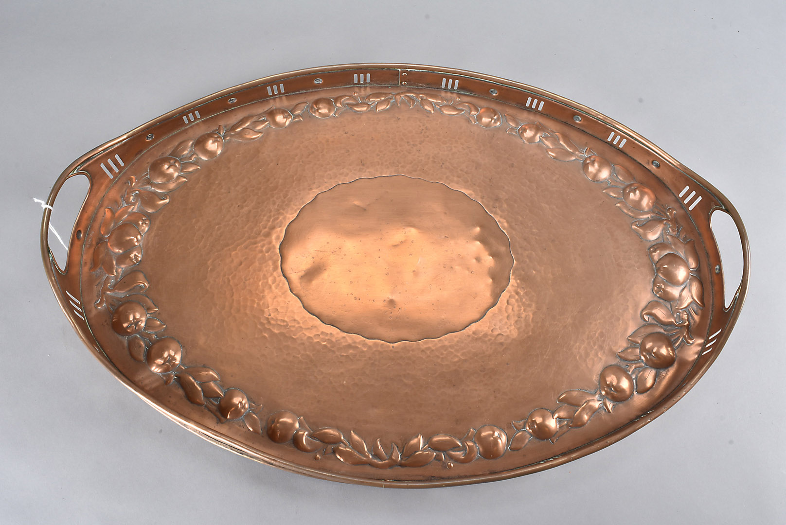 A Newlyn arts and crafts copper twin handled tray, of oval design, with pierced gallery and raised