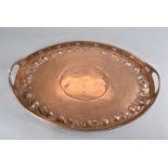 A Newlyn arts and crafts copper twin handled tray, of oval design, with pierced gallery and raised