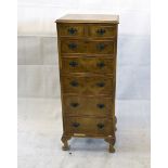 A reproduction burr walnut veneered tallboy, of two short drawers over five graduating drawers on