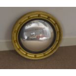 Two early 20th Century gilt convex hall mirrors, one surmounted with an eagle, 63 cm x 42 wide,