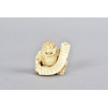A Tokyo School Late Meiji period carved ivory Netsuke figure, in the form of a seated gentleman