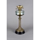 An Edwardian oil lamp, brass column support, blue glass reservoir, ornate frosted shade, all on a
