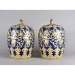 A pair of continental porcelain ovoid jars and covers, with an all over scroll and floral gilt