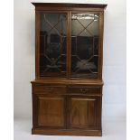 A Victorian mahogany elevated bookcase, the top with astragal glazed doors with adjustable wooden
