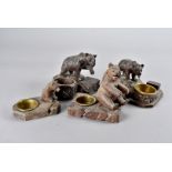 A collection of Black Forest carved bear mounted ashtrays and matchbox holders, some carved