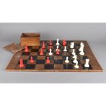 A 19th Century ivory Staunton style chess set, in white and red, together with leather folding board