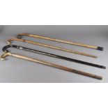 A collection of miscellaneous items including a brass carriage timepiece, four walking sticks, a