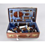 An Edwardian leather cased travelling dressing table set, by Mappin and Webb, the tortoiseshell