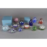 A collection of glass paperweights, including a Murano millefiori example, two cased Strathearn