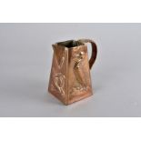 A Newlyn copper arts and crafts jug, of triangular form, with caned strap handle, having two