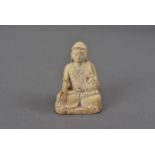 A 19th century painted ivory Buddha, seated in the Bhumisparsha Mudra in the lotus position 7 cm H