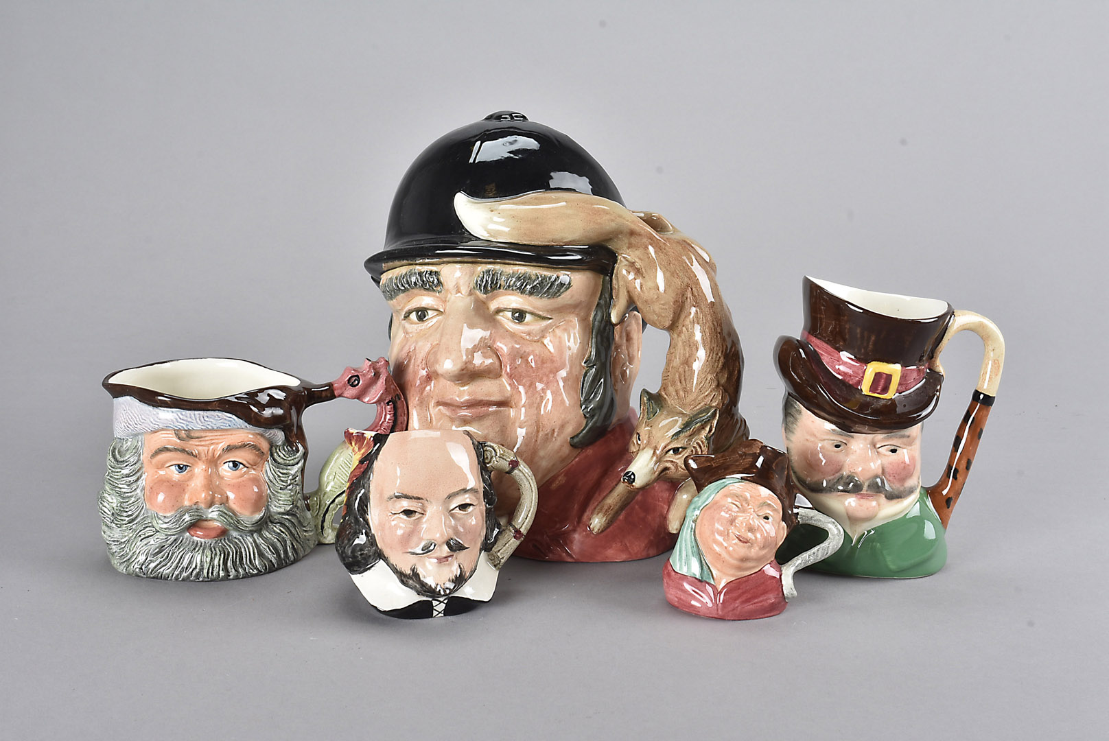 A collection of character jugs, Royal Doulton, Burleighware, Sandlandware and other factories