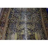 A wool Persian rug, the central all over panel decorated with a garden design of ferns, flowers