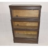 An Inglesants oak veneered three section graduated bookcase, with pressed metal name plate,