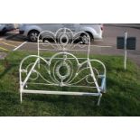 An Edwardian cast iron white painted double bed frame, with central oval and scroll design 140 cm