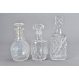 A collection of glass decanters, and six square based cut glass goblets, the decanters comprising