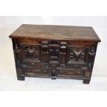 An 18th Century oak panel chest, with architectural frieze to front, fitted with two later drawers