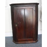 A Georgian oak corner wall cupboard, 93 cm high and 67 cm wide, AF