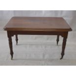 A late Victorian mahogany table, of rectangular form on turned tapering legs and brass and ceramic