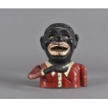 A cast iron novelty money bank, Jolly Nigger', 15 cm high