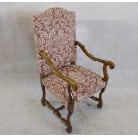 A walnut framed upholstered armchair, with scroll arms and supports in an all over red and white