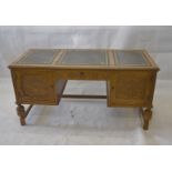 A Jaycee Furniture Ltd oak veneered desk, with carved frieze drawer flanked by carved panel doors,