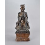 A 17th Century Chinese gilded bronze figure of a seated Emperor, in mianguan hat, seated on
