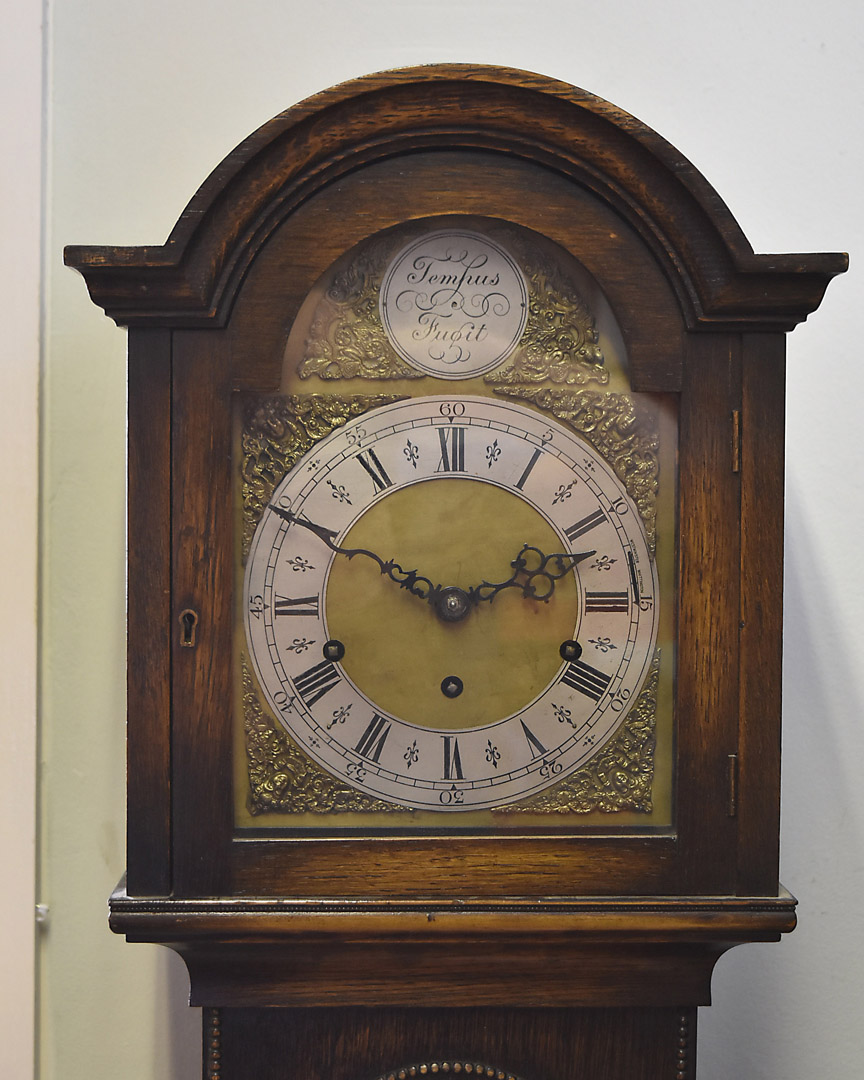 A 20th Century oak cased grandmother clock, with brass and steel chapter ring, eight day movement,