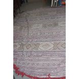 A modern Moroccan woollen kilim style carpet, having red, green and white geometric banding, 392