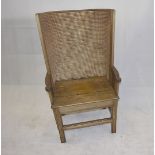 A 19th Century Orkney chair, the pine panel seat with rush woven curved back, having iron screws,
