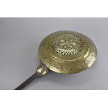 Two 18th Century brass and steel bed warmers, with circular pierced decoration, 108 cm high,
