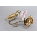 A gilt painted cherub wall light, having flared glass lamp shade, together with a gilt painted