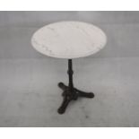 A cast iron and marble topped garden table, circular top, 60 cm diameter x 72 cm high