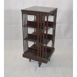An Edwardian mahogany revolving bookcase, three tier with slatted sides, ceramic castors, 50 cm