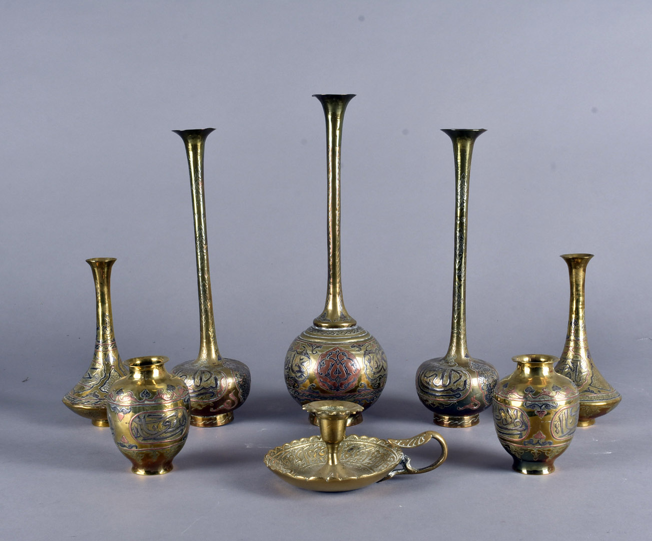 A collection of early 20th Century mixed metal Islamic items, including a pair of tapered vases,