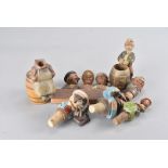 A collection of Black Forest carved figural items, including bottle stoppers, match stick holders,