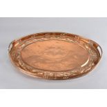 A Newlyn copper arts and crafts twin handled oval tray, with pierced gallery and raised handles, the