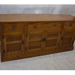 A Jaycee Furniture Ltd oak veneered sideboard, fitted with three frieze drawers above a pair of