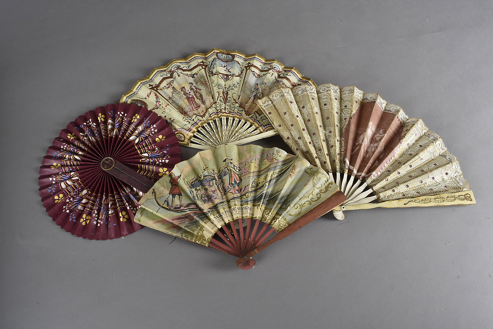 A collection of eight souvenir fans, one of circular form with printed scene of bull fight and other