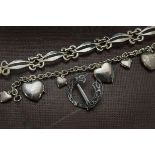 A modern silver bracelet, together with another with six heart shaped lockets and a Celtic brooch (