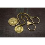 Two Middle Eastern gold key rings, one with a German 1889 20 marks gold coin, the other with