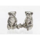 A pair of Edwardian silver teddy bear peppers by William Vale & Sons, modelled seated with