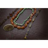 Five vintage items of jewellery, including a Chinese green hardstone bean child's necklace,