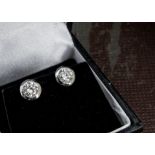 A modern pair of GIA certificated diamond stud earrings, the 18ct white gold rubbed over stud mounts