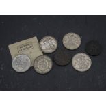 A collection of coins, including several notable crowns such as an 1891, a 1927, a 1937, two