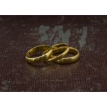 Three 22ct gold wedding bands, all plain with hallmarks, 11.3g (3)